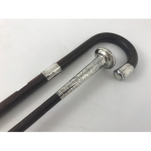 1828 - SILVER TOPPED ENGRAVED LADIES PARASOL AND A GENTS WALKING STICK WITH SILVER TOP & BAND