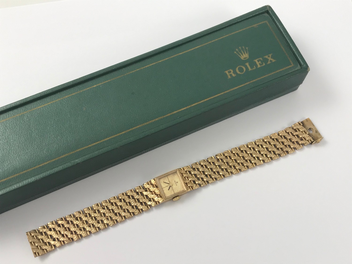 A LADIES GOLD ROLEX WRIST WATCH WITH SQUARE FACE HAVING ENGINE