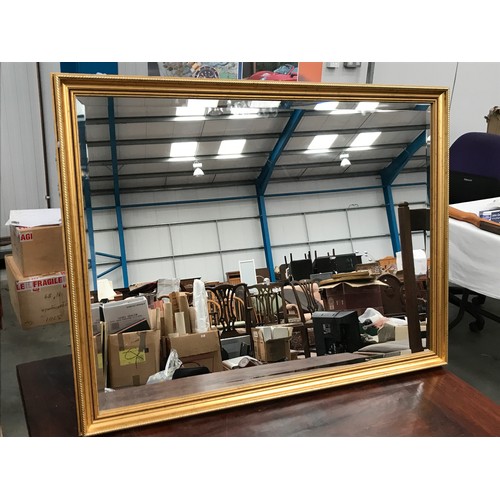 633 - GILT FRAMED BEVELLED MIRROR, approx. 110 x 86 cm