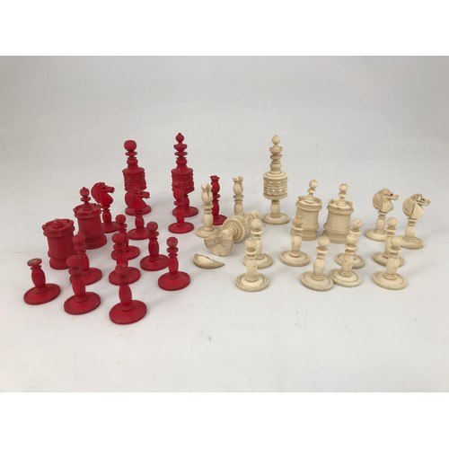 1815 - 19th CENTURY CARVED RED AND WHITE STAINED CHESS SET