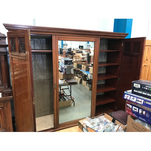 135 - LARGE VICTORIAN MAHOGANY TRIPLE WARDROBE WITH CENTRAL MIRRORED DOOR, STAMPED GARRETT & NUMBERED