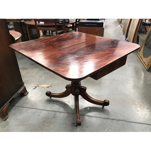 357 - MAHOGANY FOLD OVER TEA TABLE ON TURNED PEDESTAL WITH 4 SPLAYED LEGS AND CASTERS