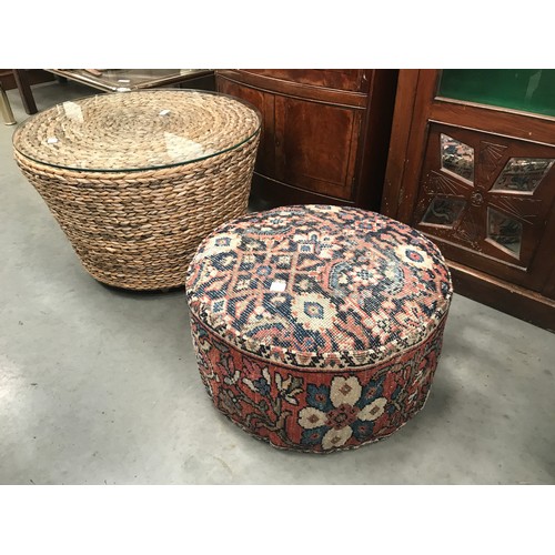 144 - ROUND RATTAN OCCASIONAL TABLE WITH GLASS TOP TOGETHER WITH A KELIM POUFFE