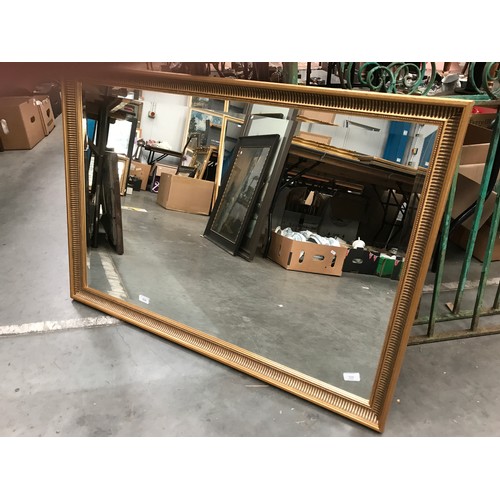 630 - RECTANGULAR BEVELLED MIRROR WITH GILT SURROUND