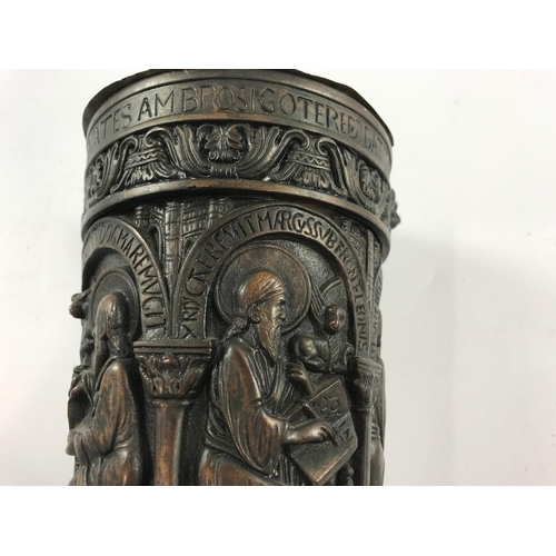 1071 - BRONZE EFFECT STYLE METAL POT WITH RELIGIOUS SCENES AND ICONS APPROX 18CM TALL