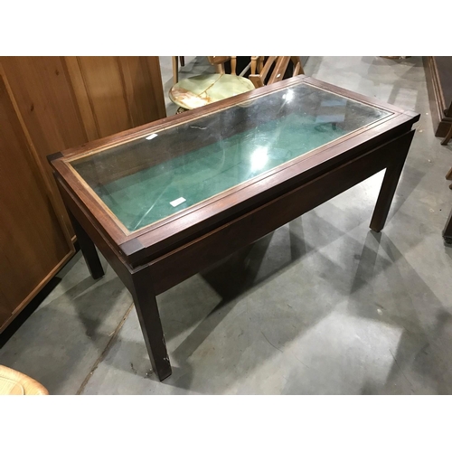 324 - A GLASS TOPPED DISPLAY COFFEE TABLE