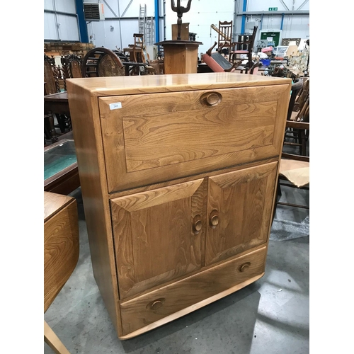 349 - ERCOL ‘BLONDE’ CABINET WITH FALL FRONT OVER A PAIR OF CUPBOARD DOORS WITH SINGLE DRAWER TO BASE ON C... 