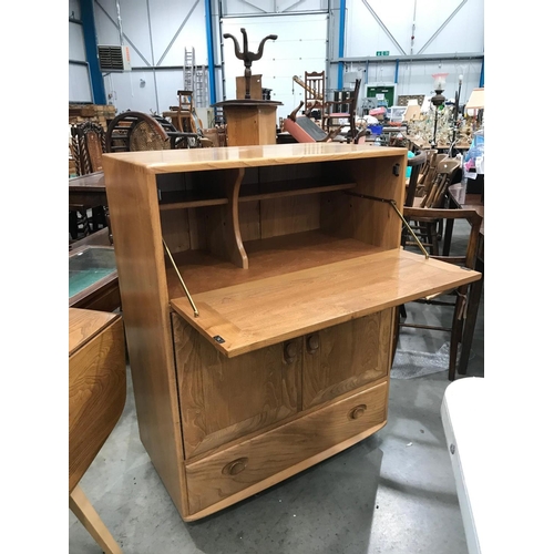 349 - ERCOL ‘BLONDE’ CABINET WITH FALL FRONT OVER A PAIR OF CUPBOARD DOORS WITH SINGLE DRAWER TO BASE ON C... 