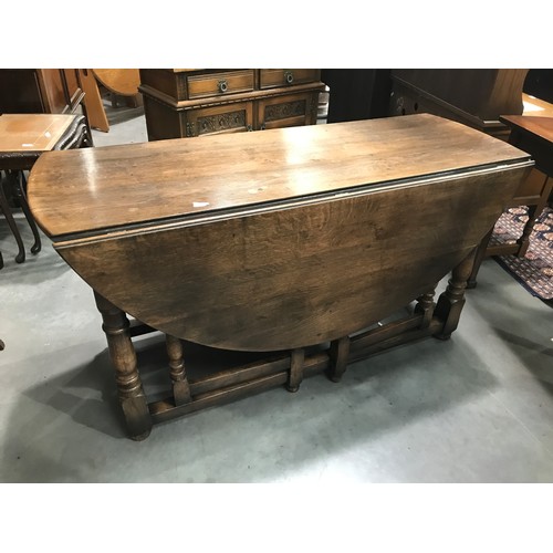 80 - OAK DROP LEAF DINING TABLE IN THE BYLAWS STYLE, END DRAWER, approx. 146 cm round