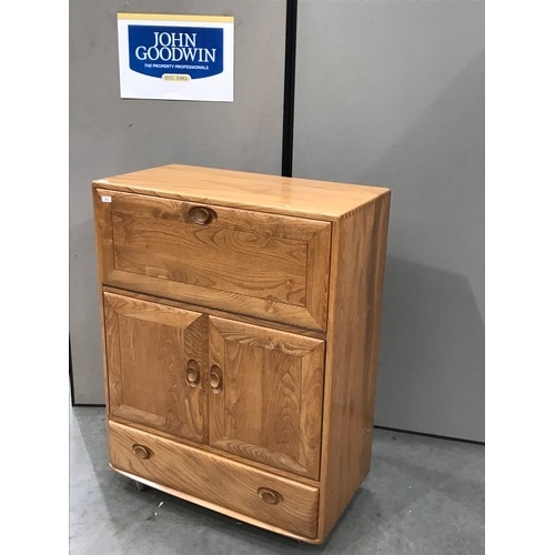 349 - ERCOL ‘BLONDE’ CABINET WITH FALL FRONT OVER A PAIR OF CUPBOARD DOORS WITH SINGLE DRAWER TO BASE ON C... 