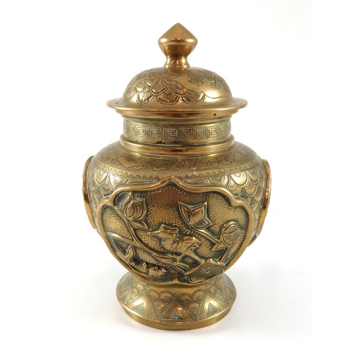 440 - ORIENTAL BRASS VASE AND COVER WITH RELIEF DECORATION AND SEAL MARK TO BASE, APPROX. 24 cm H.