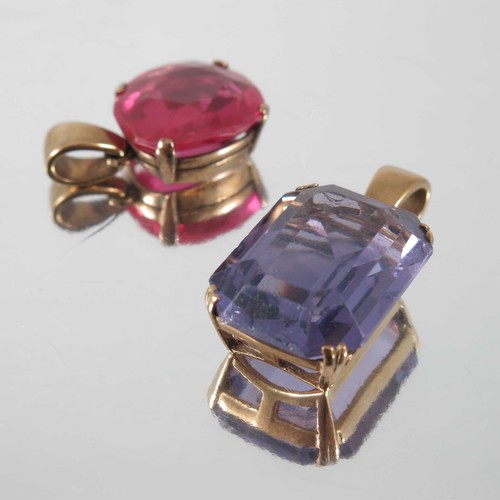 750 - 2 YELLOW GOLD MOUNTED PENDANTS 1 SET WITH A RED STONE, THE OTHER A PURPLE STONE