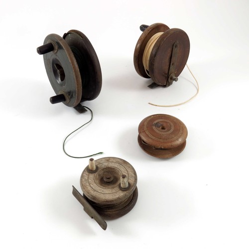 494 - 3 WOODEN FISHING REELS, LARGEST 4.5 ins. AND A WOODEN SPOOL