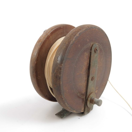 494 - 3 WOODEN FISHING REELS, LARGEST 4.5 ins. AND A WOODEN SPOOL