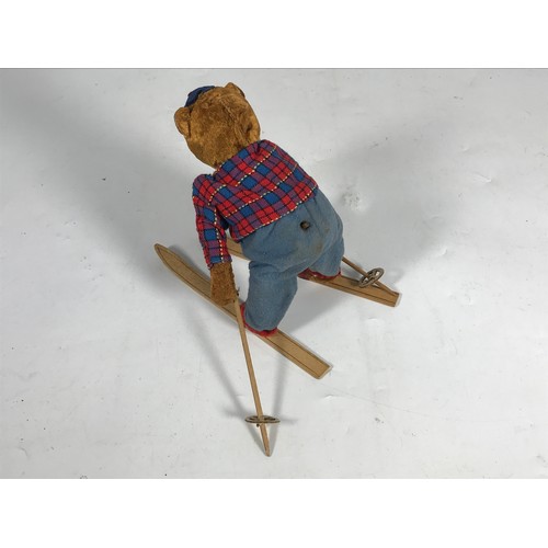 192 - CLOCKWORK TOY, A GERMAN STYLE, SKIING BEAR, APPROX 18CM TALL, ON A PAIR OF SKIS, ALPINE CAP.