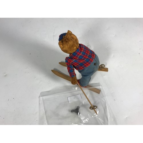 192 - CLOCKWORK TOY, A GERMAN STYLE, SKIING BEAR, APPROX 18CM TALL, ON A PAIR OF SKIS, ALPINE CAP.