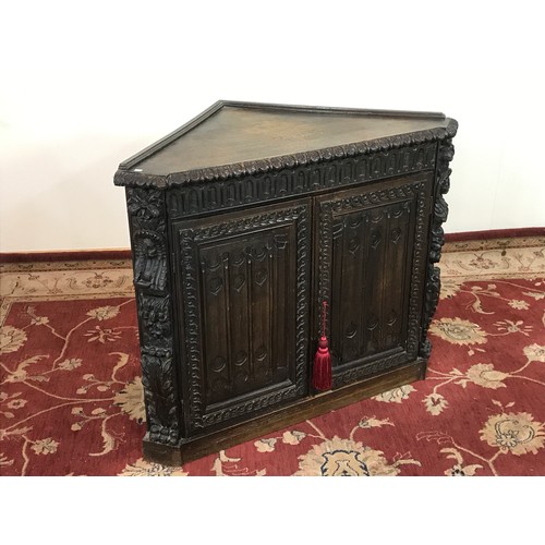 249 - GOTHIC STYLE HEAVILY CARVED CORNER CABINET 85CM H X 105CM W