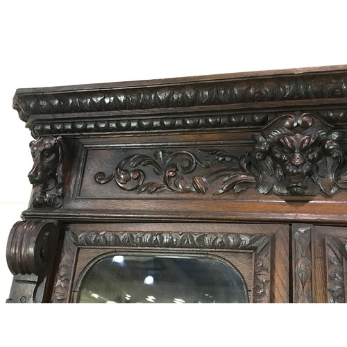 12 - IMPRESSIVE OAK CARVED GOTHIC STYLE GLAZED CORNER CABINET, IN 2 SECTIONS 240CM H 125CM W