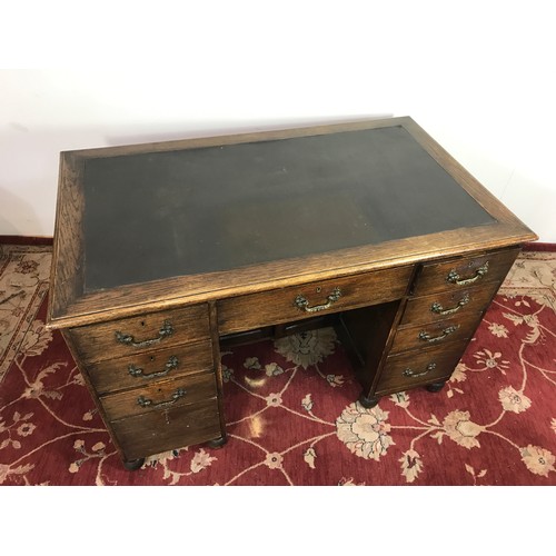 321 - OAK TWIN PEDESTAL DESK WITH TOOLED LEATHER TOP 121cm wide and 79cm tall