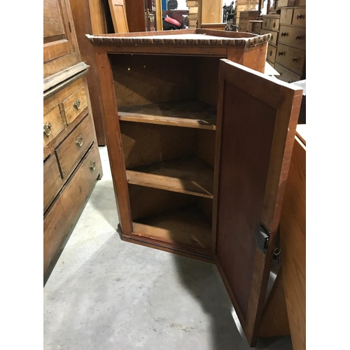 154 - STAINED PINE HANGING CORNER CUPBOARD 66cm wide and  92cm tall