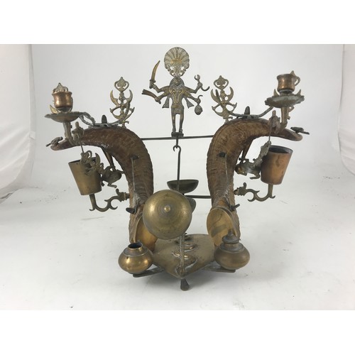 475 - AN UNUSUAL ANGLO INDIAN BRASS AND RAMS HORN DESK STAND WITH INK WELLS, SERVANTS BELLS, CANDLESTICKS ... 