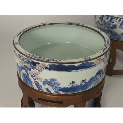 318 - PAIR OF ORIENTAL BLUE AND WHITE STRAIGHT SIDED CIRCULAR BOWLS EACH APPROX. 22 cms DIAMETER WITH HARD... 