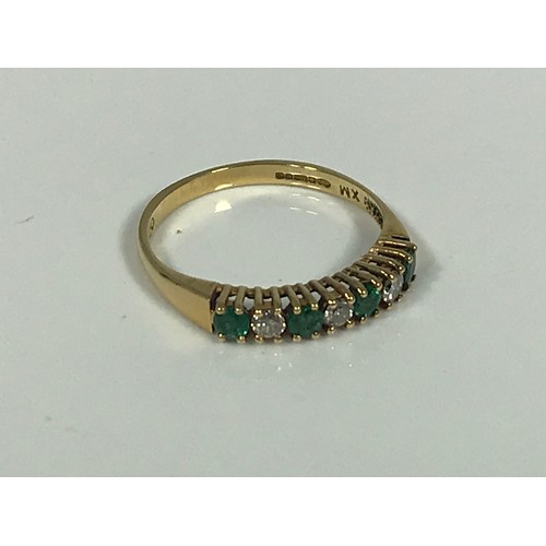 784 - 18 CARAT GOLD EMERALD AND DIAMOND RING