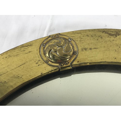 88 - CIRCULAR ARTS AND CRAFTS MIRROR WITH BRASS SURROUND DECORATED WITH ROUNDELS AND BEARING A LIBERTY AN... 