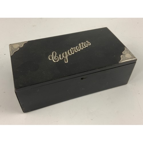 495 - EBONISED RECTANGULAR CIGARETTE BOX WITH HINGED LID AND ORNATE SILVER CORNER MOUNTS AND LETTERING