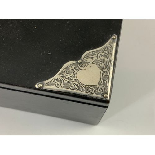 495 - EBONISED RECTANGULAR CIGARETTE BOX WITH HINGED LID AND ORNATE SILVER CORNER MOUNTS AND LETTERING