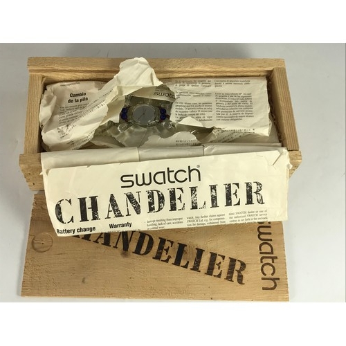 838 - SWATCH CHANDELIER LADIES WRIST WATCH WITH ORIGINAL BOX AND STAND TOGETHER WITH A ZIPPO PRESENTATION ... 