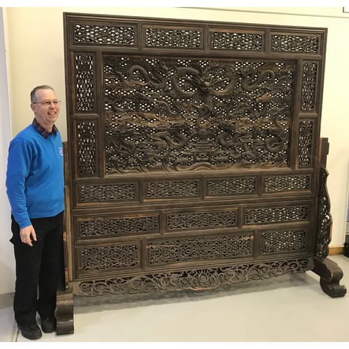 454 - LARGE AND VERY IMPRESSIVE CARVED AND PIERCED ORIENTAL 'SEVEN DRAGONS' SCREEN ON STAND,  APPROX. 229 ... 