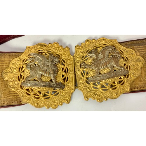 209 - MILITARY STYLE BUCKLE BELT, WITH DRAGON BUCKLES, GILT COLOURED FRONT AND RED INNER