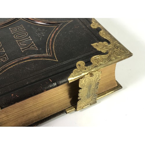 240 - FAMILY BIBLE WITH LEATHER BINDING AND ORNATE GILT BRASS CLASPS