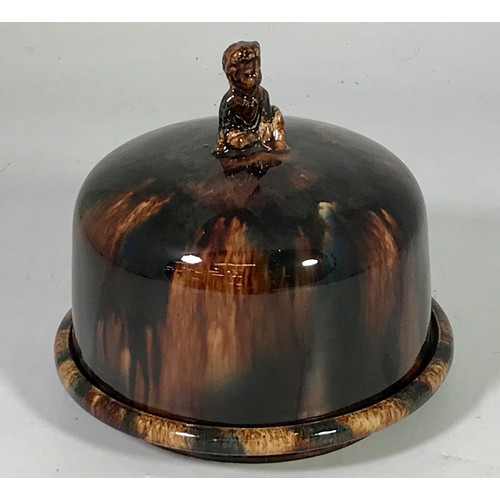 1693 - TREACLE GLAZED CHEESE DISH WITH FIGURAL FINIAL