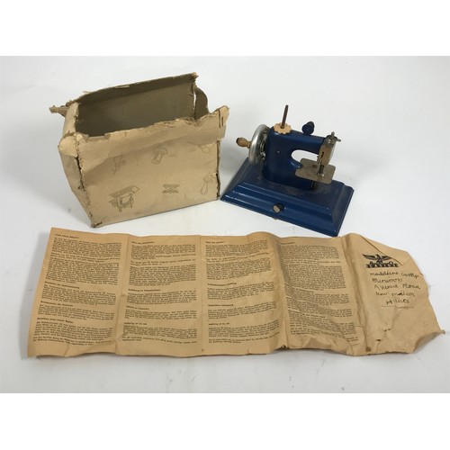 194 - CHILD’S CASIGE TIN PLATE SEWING MACHINE IN ORIGINAL BOX WITH INSTRUCTIONS