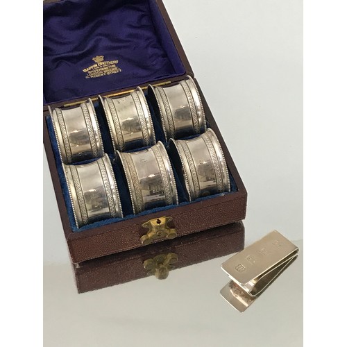 3420 - SET OF MAPPIN AND WEBB SERVIETTE RINGS TOGETHER WITH A SILVER MONEY CLIP