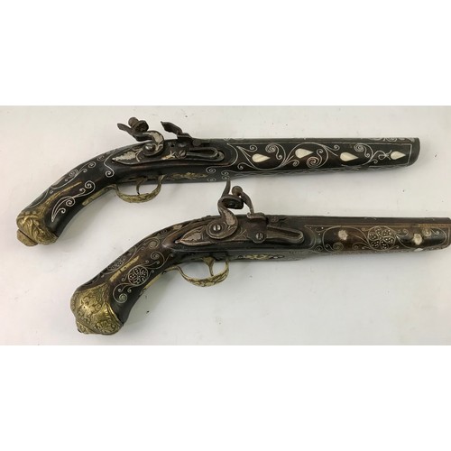 3065 - 2 TURKISH/ INDIAN STYLE DECORATIVE FLINT LOCK PISTOLS HAVING MOTHER OF PEARL INLAID STOCKS POSSIBLY