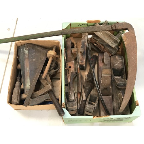 293 - 2 BOXES OF OLD PLANES, SAWS ETC. TOGETHER WITH A SCYTHE WITH 2 NEW BLADES