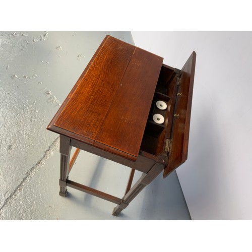 205 - UNUSUAL OAK DESK WITH CONCEALED COMPARTMENT HAVING INKWELLS AND A FRIEZE DRAWER