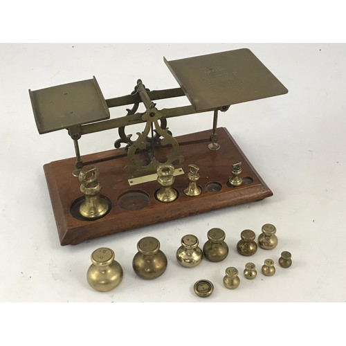 302 - SET OF POSTAL SCALES ON WOODEN BASE TOGETHER WITH VARIOUS BRASS WEIGHTS