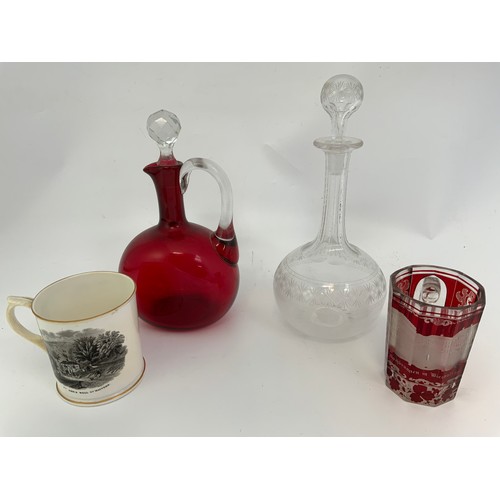 125 - FLASHED BOHEMIAN GLASS TANKARD, A RUBY GLASS DECANTER AND AN ETCHED GLASS DITTO