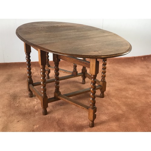 58 - OAK OVAL TOP DROP LEAF DINING TABLE WITH BARLEY TWIST SUPPORTS