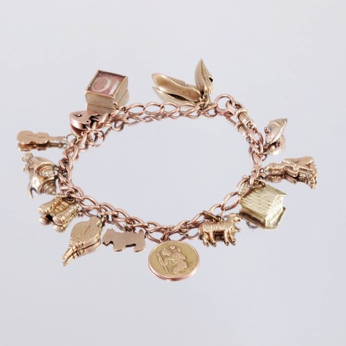 674 - 9ct GOLD CHARM BRACELET AND CHARMS, APPROX. 27.5g GROSS