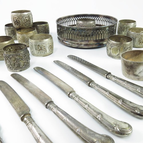 387 - SILVER POWDER COMPACT, PISTOL HANDLED KNIVES, INDIAN SERVIETTE RINGS, PLATED BOTTLE COASTERS, SILVER... 