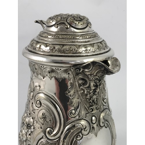 407 - AN IMPRESSIVE 17TH CENTURY STYLE LIDDED JUG WITH MASK SPOUT , HEAVILY EMBOSSED WITH SCROLL AND FOLIA... 