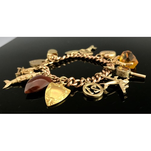 675 - 9 CARAT GOLD CHARM BRACELET WITH CHARMS AND HEART SHAPED FASTENER APPROX. 53.6G GROSS