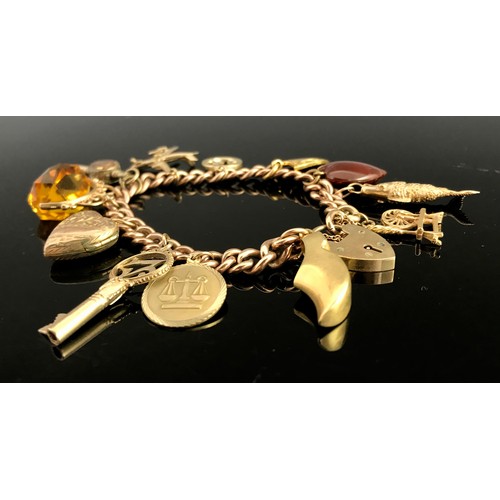 675 - 9 CARAT GOLD CHARM BRACELET WITH CHARMS AND HEART SHAPED FASTENER APPROX. 53.6G GROSS