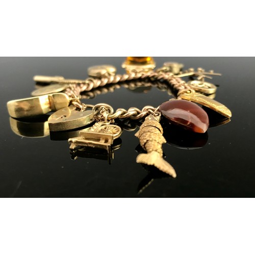 675 - 9 CARAT GOLD CHARM BRACELET WITH CHARMS AND HEART SHAPED FASTENER APPROX. 53.6G GROSS