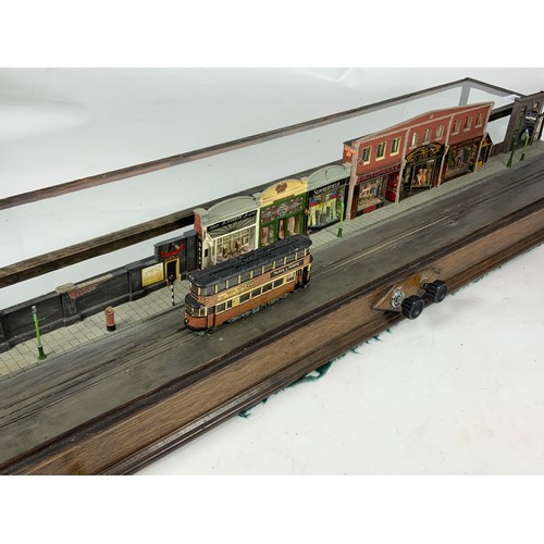 237 - MODEL STREET SCENE DIORAMA OF A TRAMWAY, ON STRAIGHT BOARD WITH BACK SCENE OF VINTAGE HOUSES. THE MO... 